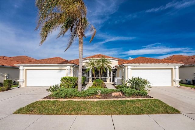 mediterranean / spanish-style home with central AC and a garage