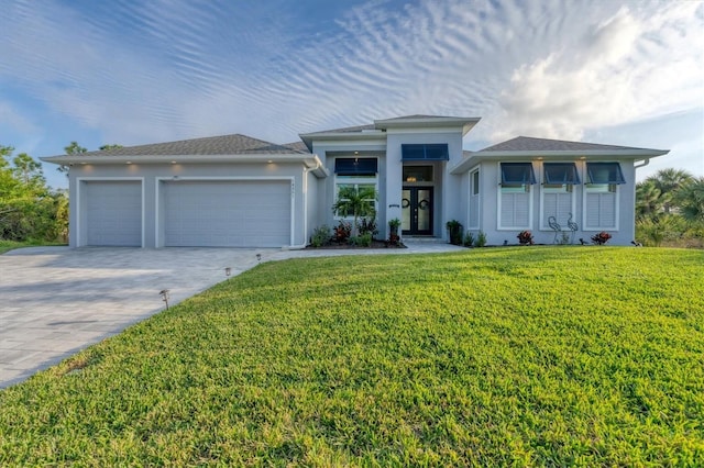 view of front of house featuring a garage and a front yard