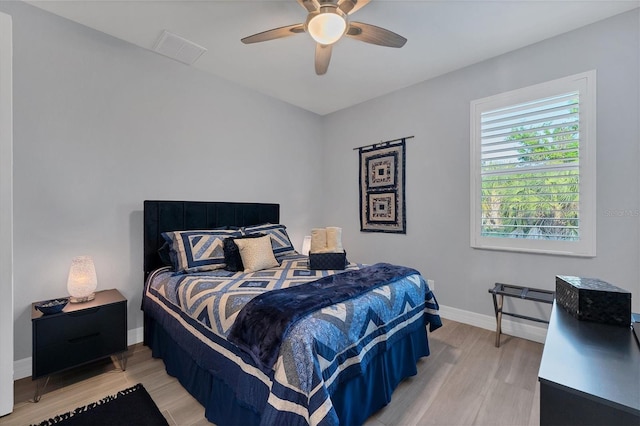 bedroom with light hardwood / wood-style flooring and ceiling fan