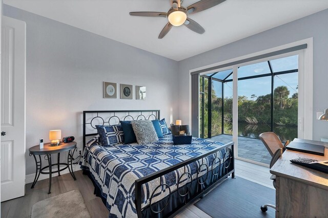 bedroom with access to exterior, ceiling fan, and wood-type flooring