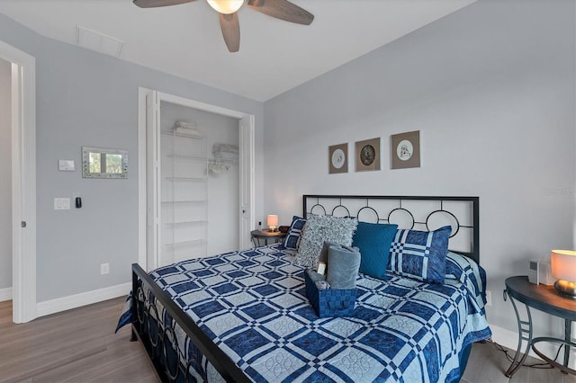 bedroom featuring hardwood / wood-style floors, ceiling fan, and a closet