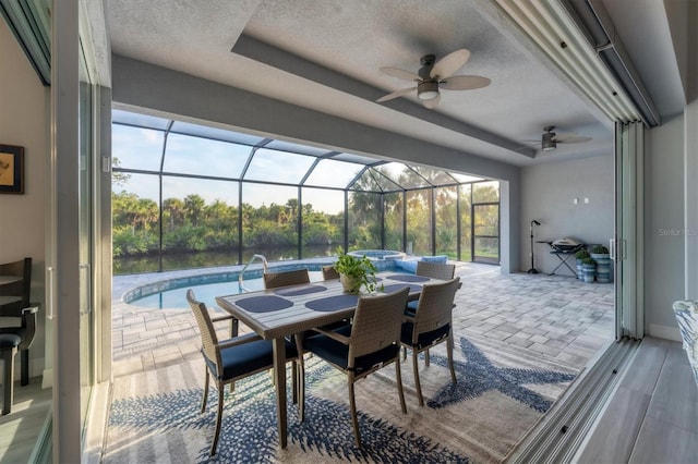 sunroom / solarium featuring ceiling fan and a pool