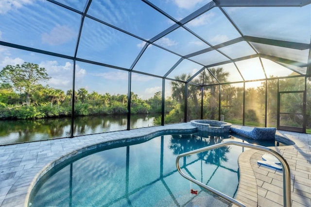 view of swimming pool featuring glass enclosure, a patio area, a water view, and an in ground hot tub