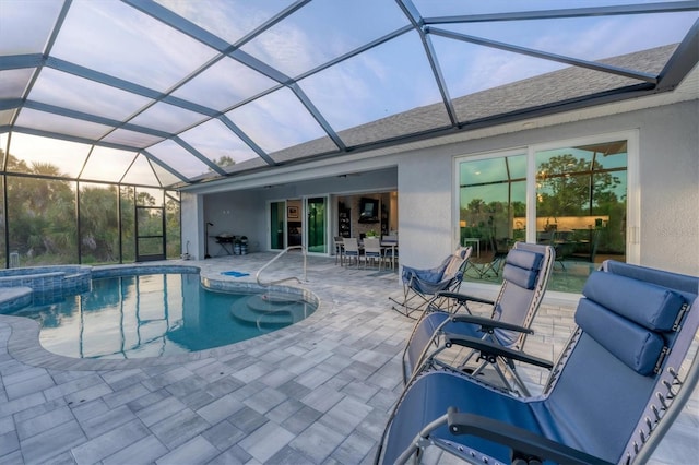 view of pool featuring a lanai, an in ground hot tub, and a patio