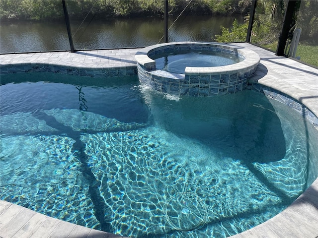 view of swimming pool with an in ground hot tub, a water view, and glass enclosure