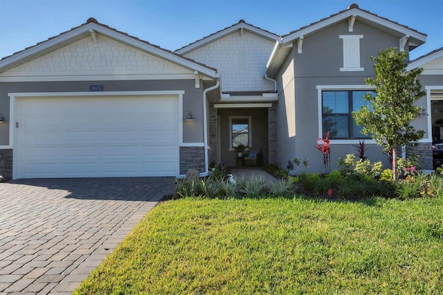 view of front of home with a front yard and a garage