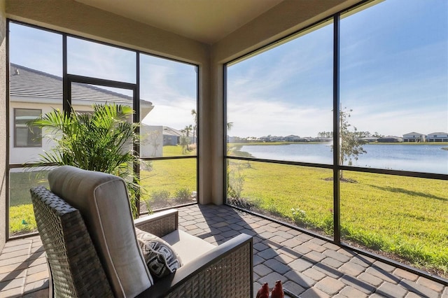 sunroom / solarium featuring a water view