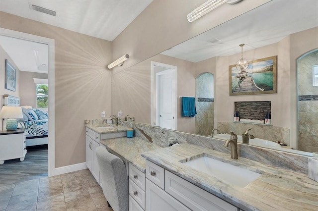 bathroom with tile patterned floors and vanity