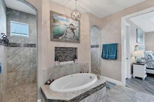 bathroom with hardwood / wood-style floors, separate shower and tub, and an inviting chandelier