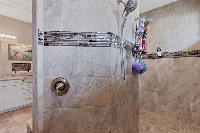 bathroom featuring vanity and tiled shower