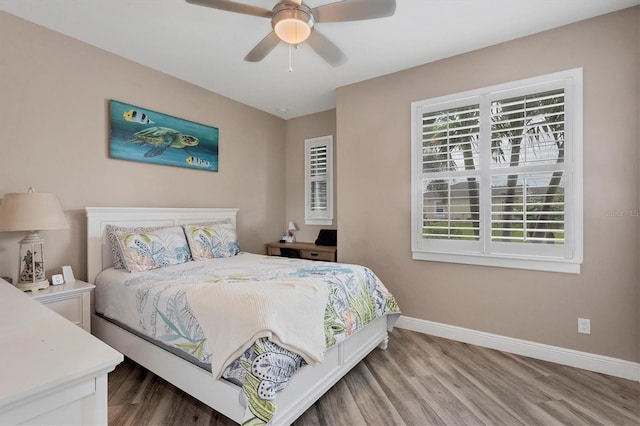 bedroom with ceiling fan and wood-type flooring