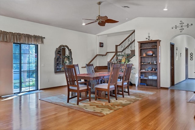 dining room with hardwood / wood-style flooring, vaulted ceiling, and ceiling fan