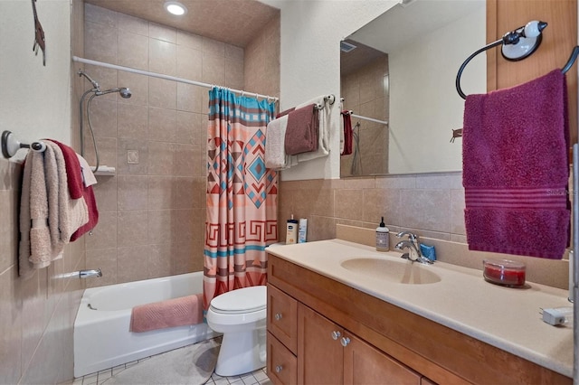 full bathroom with shower / tub combo, tile patterned floors, vanity, tile walls, and toilet