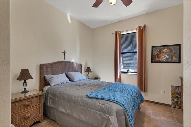 tiled bedroom featuring ceiling fan