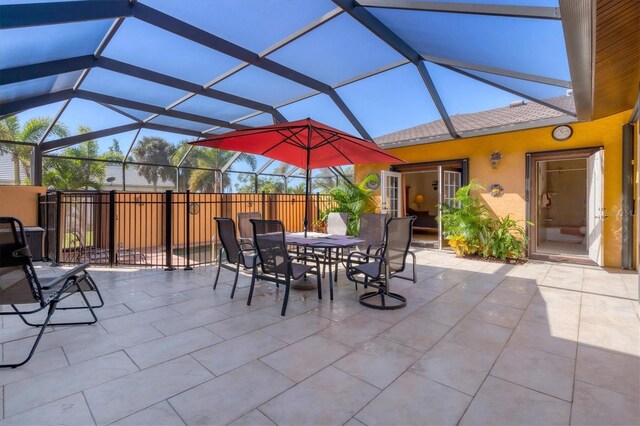 view of patio featuring glass enclosure