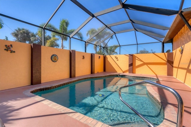 view of pool with glass enclosure