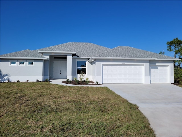 view of front of home with a front yard and a garage