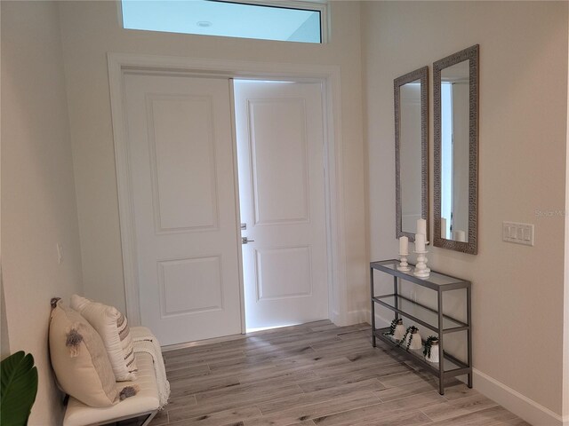 14331 Montmarte Ave, Port Charlotte, FL 33981 - foyer with baseboards and light wood-style flooring