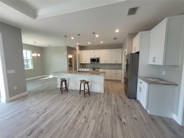 kitchen with light wood-style floors, white cabinetry, visible vents, and appliances with stainless steel finishes