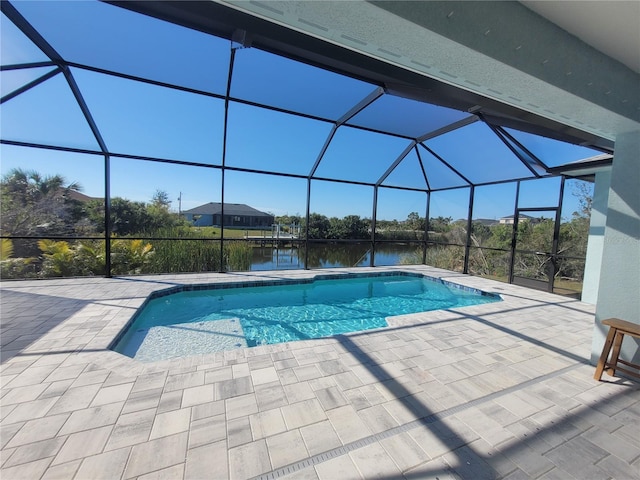 outdoor pool with a lanai, a water view, and a patio