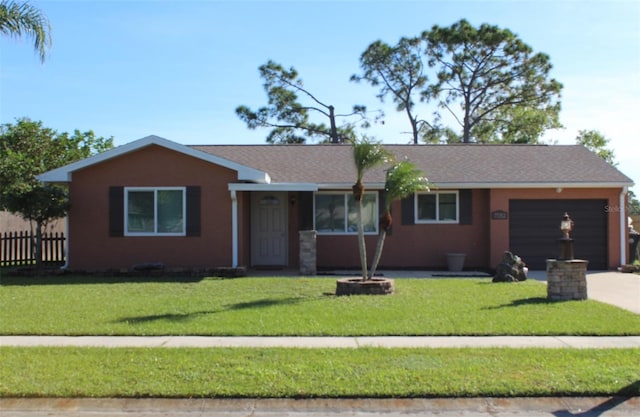 single story home featuring a garage and a front lawn