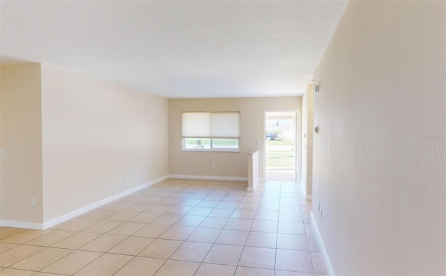 unfurnished room featuring light tile patterned floors