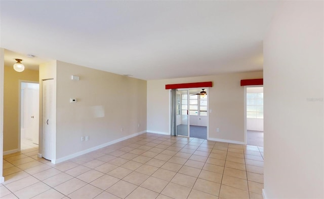 tiled empty room with ceiling fan