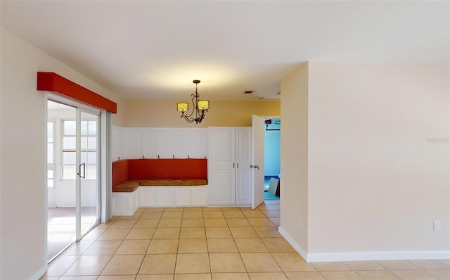 interior space featuring a chandelier and light tile patterned floors