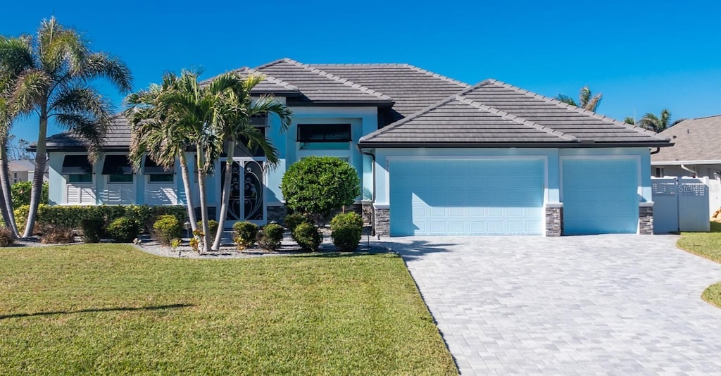 view of front of property with a front yard and a garage