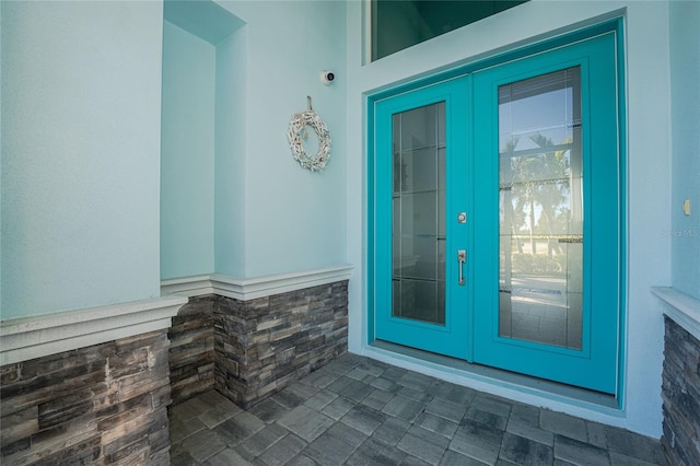 view of exterior entry featuring french doors