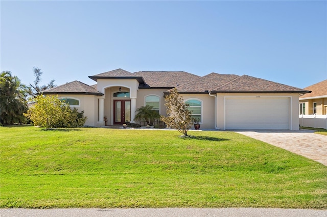 view of front of house featuring a front yard and a garage