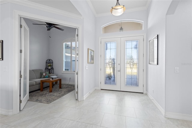 entryway featuring ceiling fan, french doors, and ornamental molding