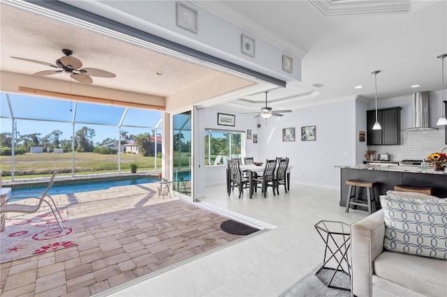 interior space with ceiling fan and crown molding