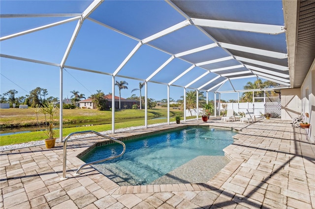 view of swimming pool with glass enclosure and a patio