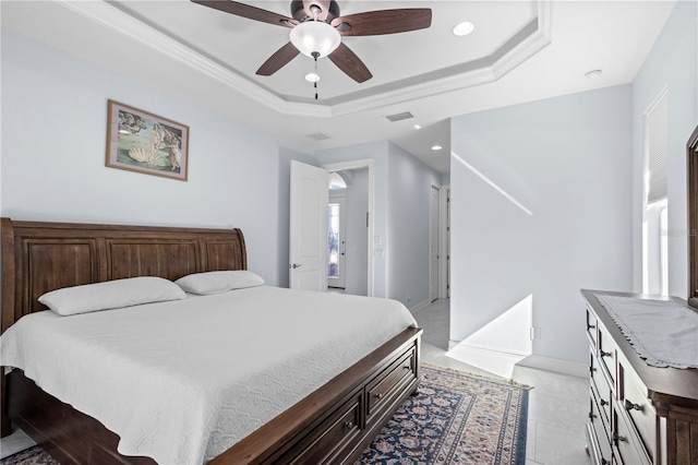 bedroom featuring a tray ceiling and ceiling fan