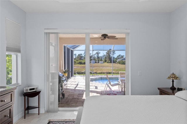 bedroom featuring access to outside, multiple windows, and light tile patterned floors