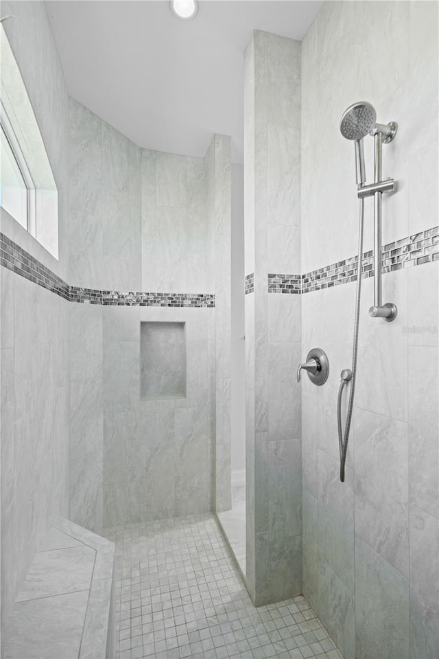 bathroom with a tile shower