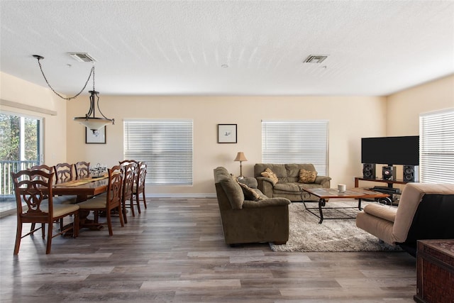 living room with dark hardwood / wood-style flooring and a textured ceiling