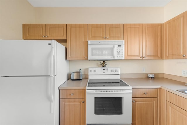 kitchen featuring light brown cabinets and white appliances