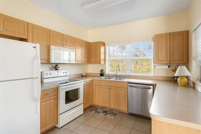 kitchen featuring light tile patterned floors, white appliances, light brown cabinetry, and sink