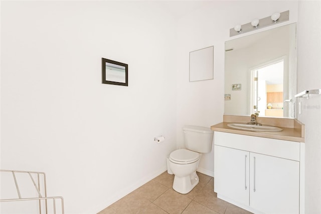 bathroom featuring tile patterned floors, vanity, and toilet