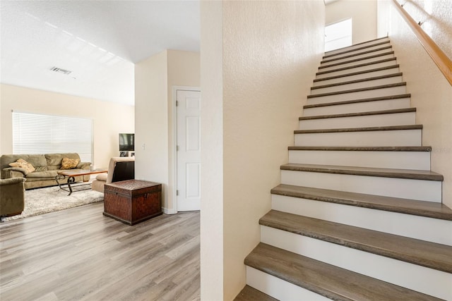 stairs featuring wood-type flooring