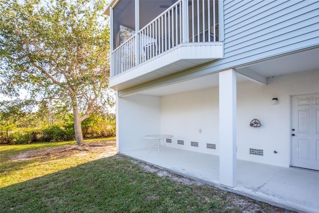 view of property exterior with a patio area and a yard