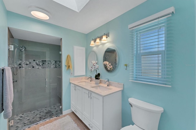 bathroom with vanity, tile patterned floors, toilet, a wealth of natural light, and an enclosed shower