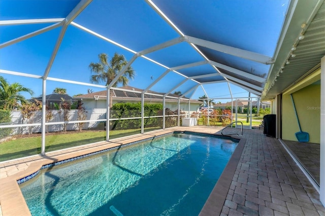 view of swimming pool with a patio and glass enclosure