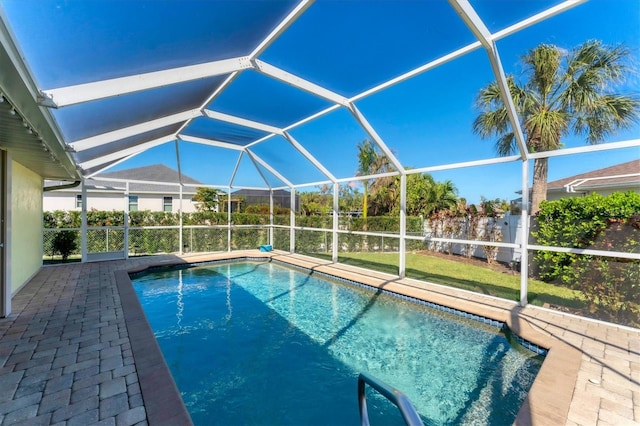 view of pool with glass enclosure