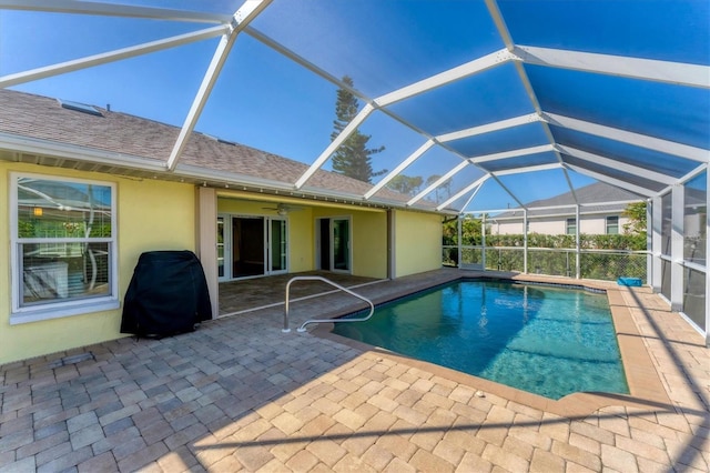 view of swimming pool featuring a lanai and a patio