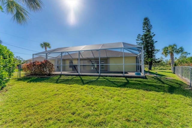 back of property with a lanai and a yard