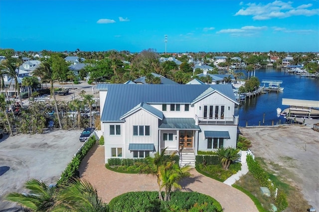 view of front of home with a balcony and a water view