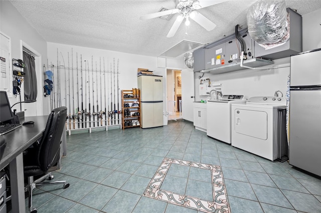 laundry room with cabinets, a textured ceiling, ceiling fan, washing machine and clothes dryer, and light tile patterned flooring